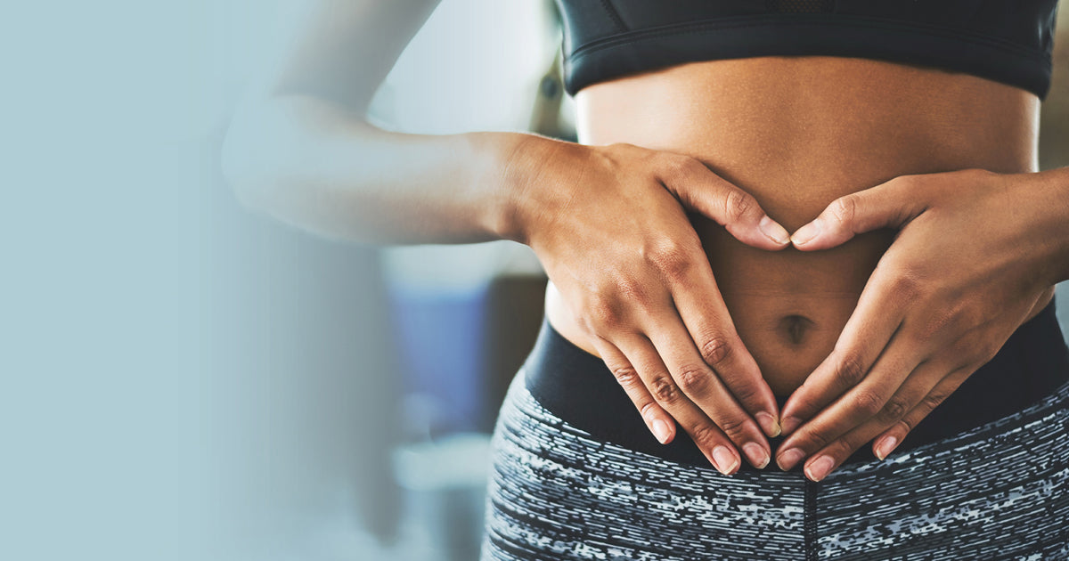 woman with hands on stomach in heart shape