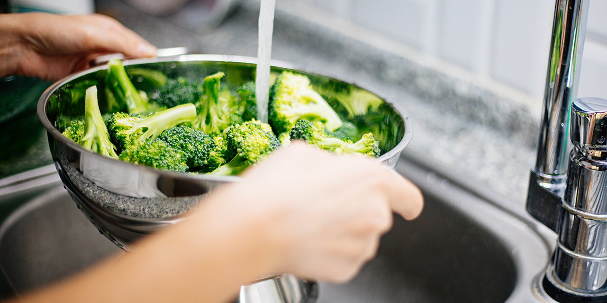 woman washing broccoli