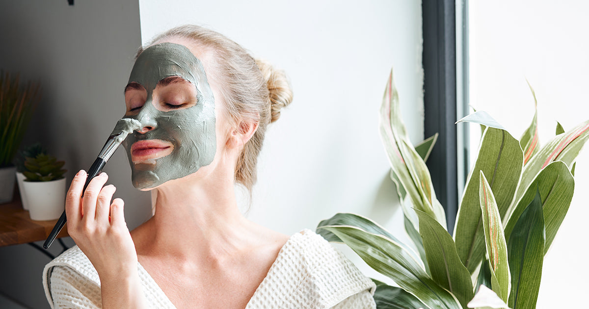 woman giving herself a facemask