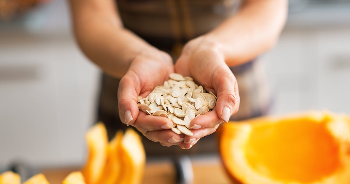 womans hands holding seeds